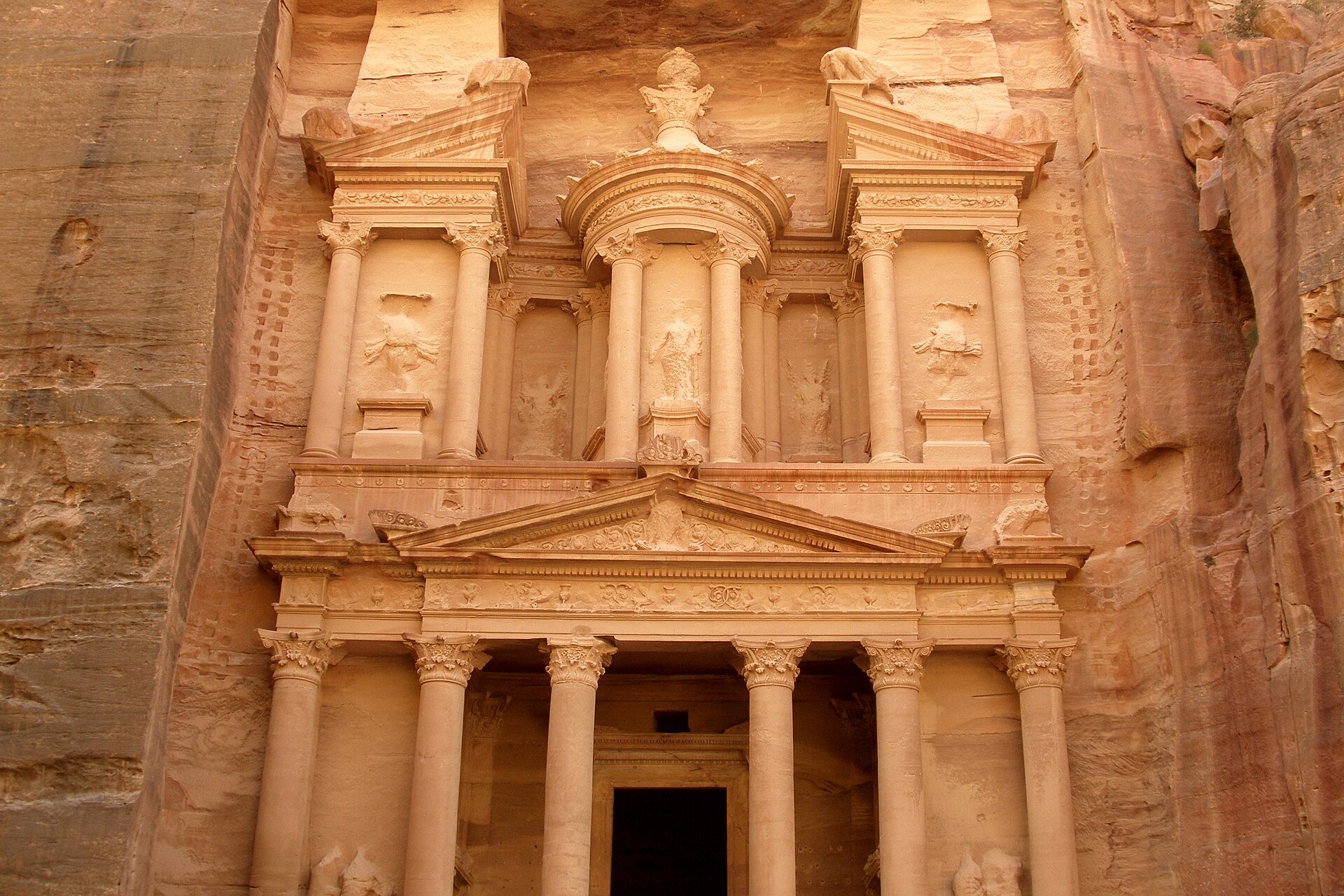 The rose-red facade of Al-Khazneh, the Treasury, carved into the cliff at the end of the Siq in Petra.