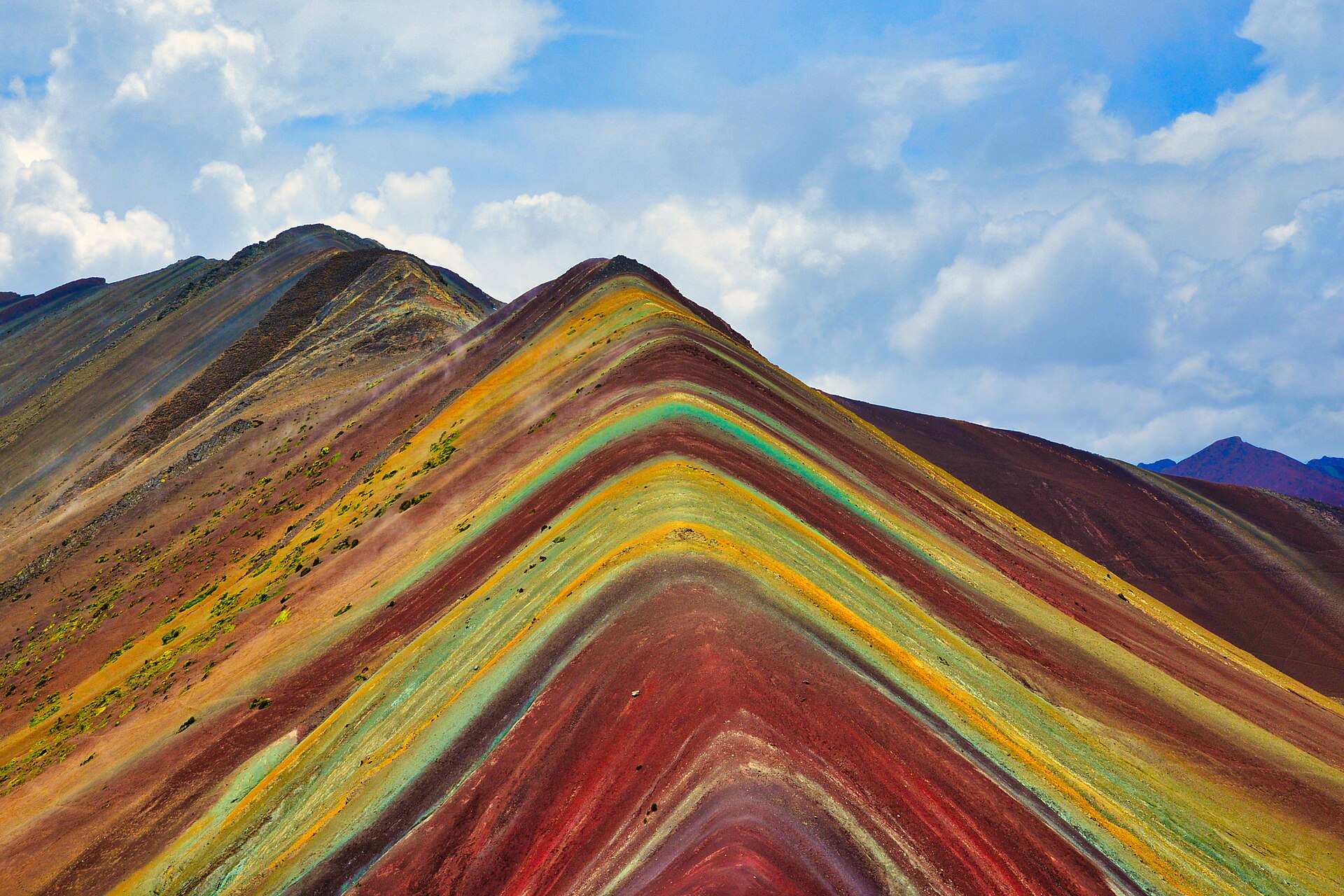Red, yellow and turquoise mineral stripes on the slopes of Vinicunca, the Rainbow Mountain near Cusco.