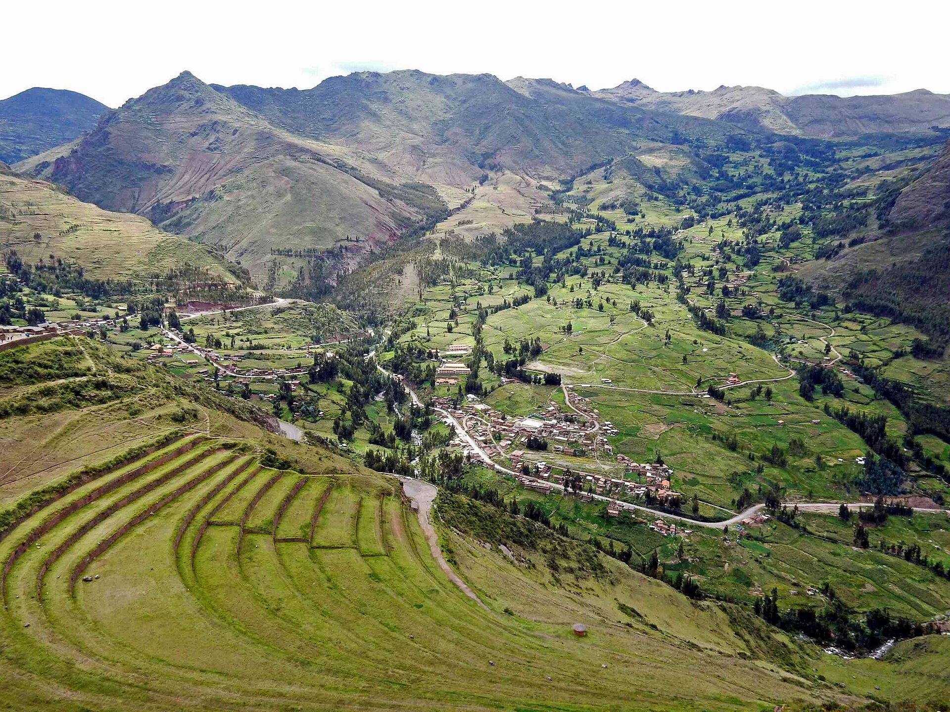 Curving Inca agricultural terraces above the green Sacred Valley at Pisac, Peru.