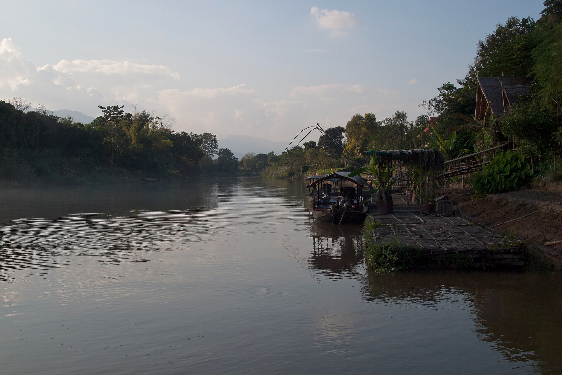 Riverside huts in morning mist on the banks of the Ping River north of Chiang Mai.