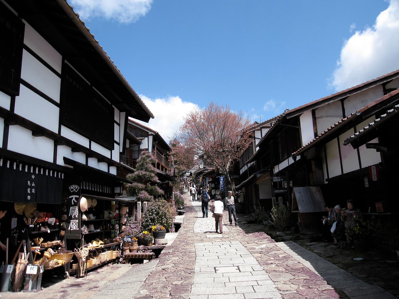 Wooden shopfronts along the stone-paved street of Magome, a post town on the Nakasendo.